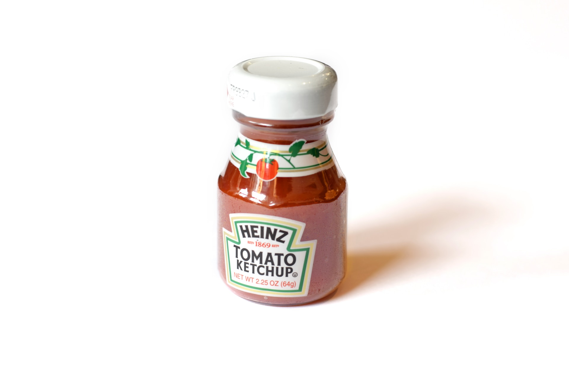 A small bottle of Heinz ketchup on a white background