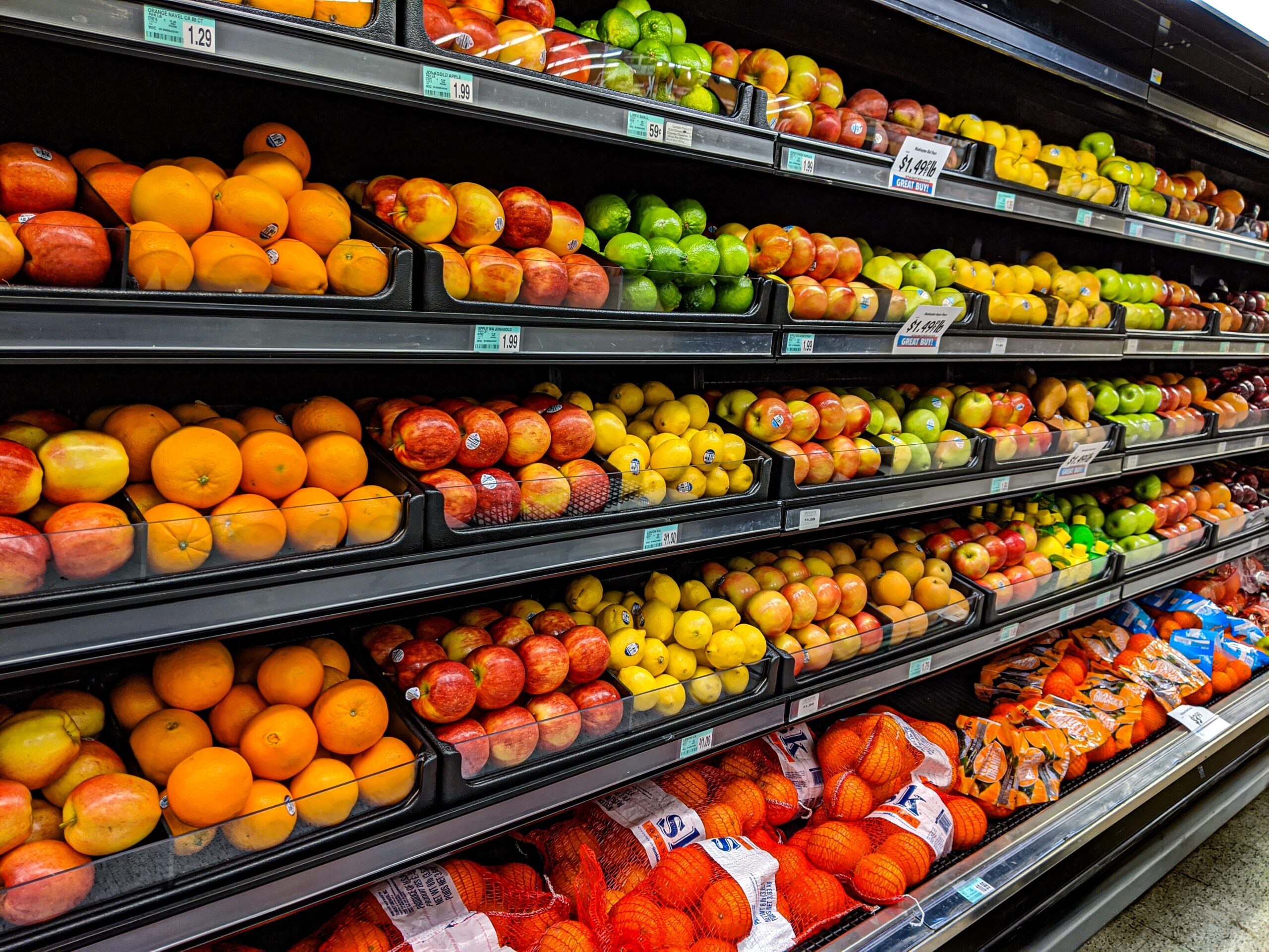 A supermarket aisle filled with fruits and vegetables.